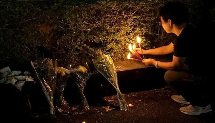 A Zhuhai resident seen lighting candles. — Reuters/file