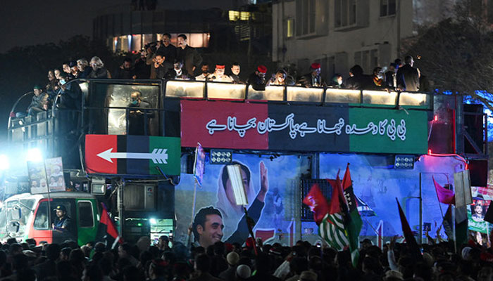 Supporters of the Pakistan Peoples Party (PPP) gather around a truck during a rally in Islamabad on March 8, 2022. — AFP