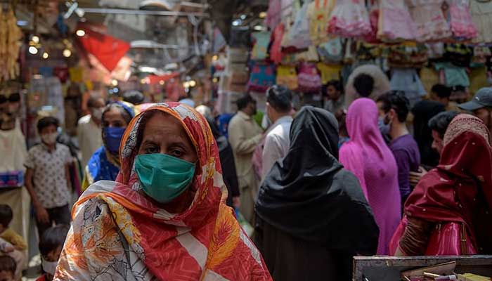 Women shop at a market in Rawalpindi. — AFP/File
