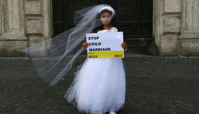 A young actress plays the role of a 10-year-old girl forced to marry a 47-year-old man during an October 2016 happening organized in Rome by Amnesty International to denounce child marriage. — AFP