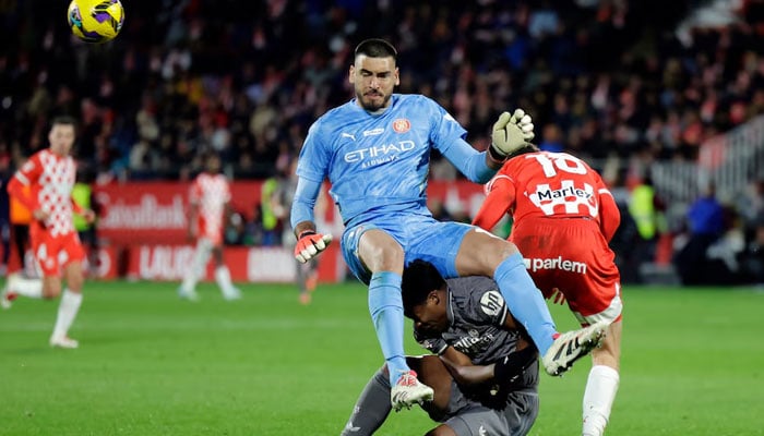 Real Madrids Endrick (under) in action with Gironas Paulo Gazzaniga and Ladislav Krejci on December 7, 2024. — Reuters