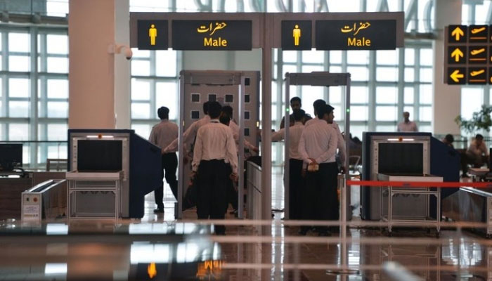 Airport staff walk through security at the new Islamabad International Airport ahead of its official opening on the outskirts of Islamabad on May 3, 2018. —AFP