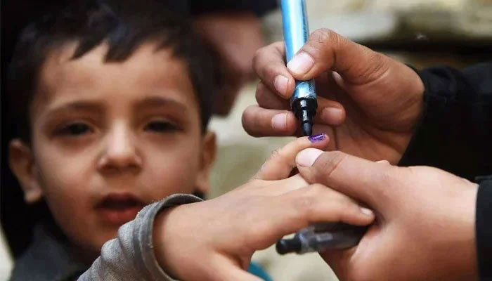 Representational image of a child being marked vaccinated by a health worker during an immunisation campaign. — AFP/File