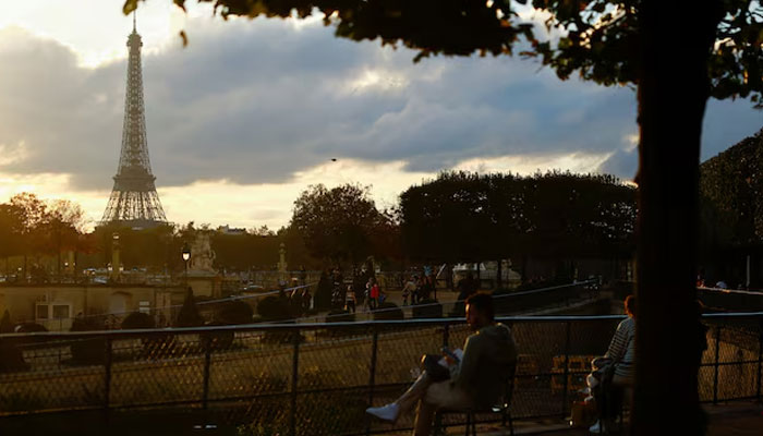 People look at the Eiffel Tower from the Jardin des Tuileries as the sun sets in Paris, France October 26, 2024. — Reuters