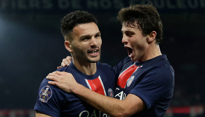 Paris St Germains Goncalo Ramos celebrates scoring their third goal with Joao Neves on  December 15, 2024. — Reuters