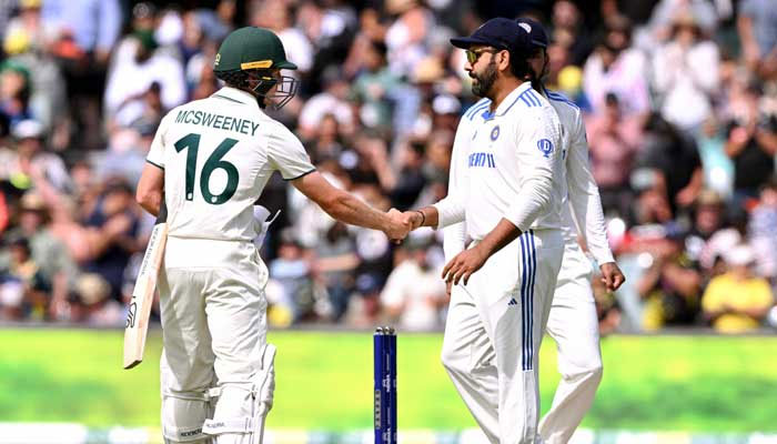 Indias captain Rohit Sharma (right) shakes hands with Australias Nathan McSweeney on the third day of the second cricket Test at the Adelaide Oval in Adelaide on December 8, 2024. — AFP