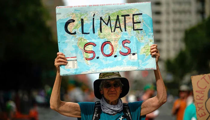 A woman holds a sign as activists mark the start of Climate Week in New York during a demonstration calling for the US government to take action on climate change and reject the use of fossil fuels in New York City, New York, US, September 17, 2023. — Reuters