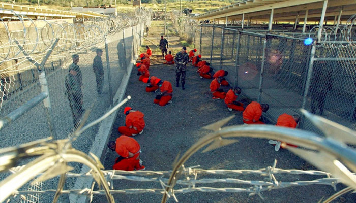 Detainees guarded by US military police sit in a holding area at the temporary Camp X-Ray, Guantanamo. —Reuters/File