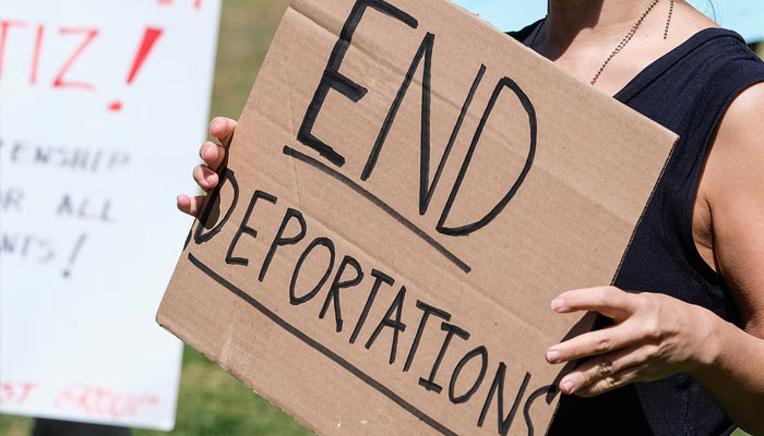Protesters holding signs take part in a rally to demand the end of deportations in US immigration policy, at Silver Lake Reservoir in Los Angeles, California, US March 6, 2021. — Reuters