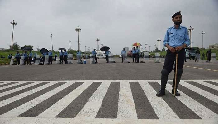 Islamabad Capital Territory Police stand guard on the road of Islamabad. — AFP/File