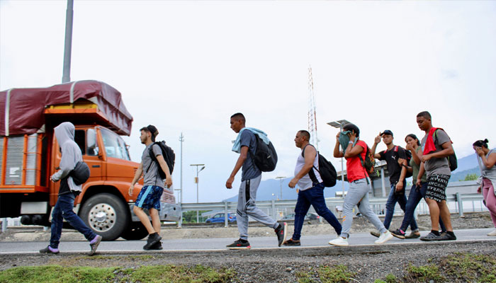 Migrants from Venezuela walk in a caravan to the US-Mexico border where hundreds of others are stranded following a deal to expel Venezuelan migrants crossing into the United States after the new US-Mexico migrant policy, in Huixtla, Mexico October 15, 2022. — Reuters