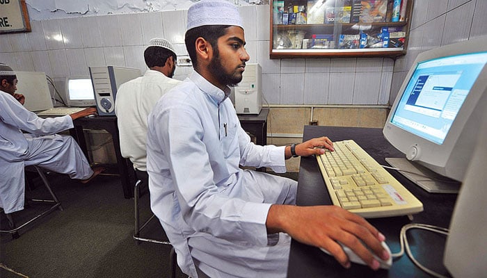 A madarsa student using a computer.— APP/File