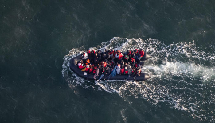 This aerial picture taken on September 16, 2023, from a police aircraft belonging to the French Police Aux Frontieres (PAF) shows migrants onboard of a dinghy used for smuggling as they attempt to cross the English Channel to Britain from a beach at Le Touquet, northern France.—AFP