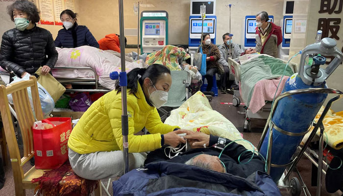 Patients lie on beds and stretchers in a hallway in the emergency department of a hospital in Shanghai, China on January 4, 2023. — Reuters