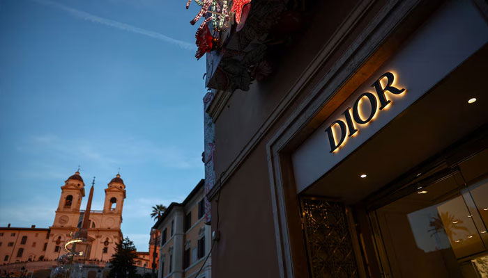 A Dior sign is seen in a shop with the Church of Santissima Trinita dei Monti and the Spanish Steps in the background, in Rome, Italy, December 18, 2024. —Reuters