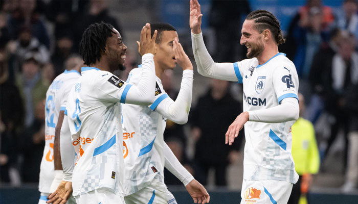 Elye Wahi (left) celebrates with Adrien Rabiot after scoring Marseilles fourth goal in their 5-1 demolition of Le Havre on Sunday .—AFP/File
