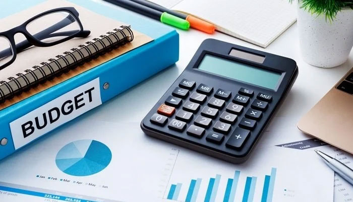 This representational image shows a calculator on the table along with a file that shows budget written on it.. — Pixabay/File