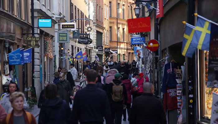 Pedestrians walk along a street in the Old Town of Stockholm, Sweden, October 17, 2024. — Reuters
