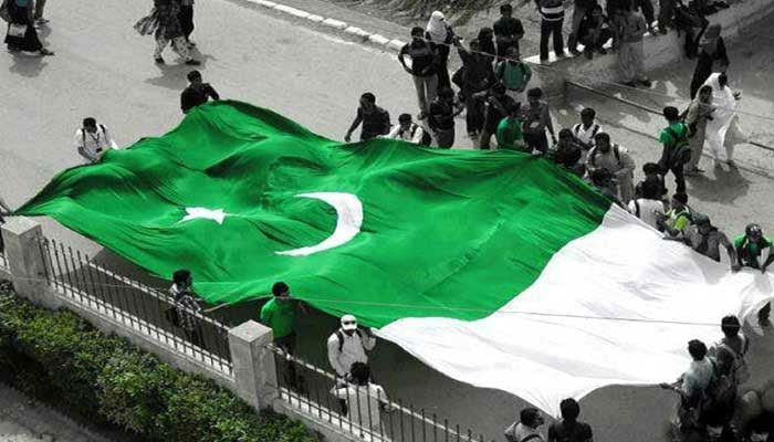 A representative image showing people holding Pakistani flag. — AFP/File
