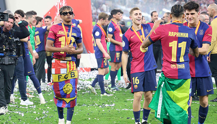 Barcelona´s Spanish forward Lamine Yamal (left) celebrates after winning the Spanish Super Cup final football match between Real Madrid and Barcelona at the King Abdullah Sport City in Jeddah on January 12, 2025. —AFP