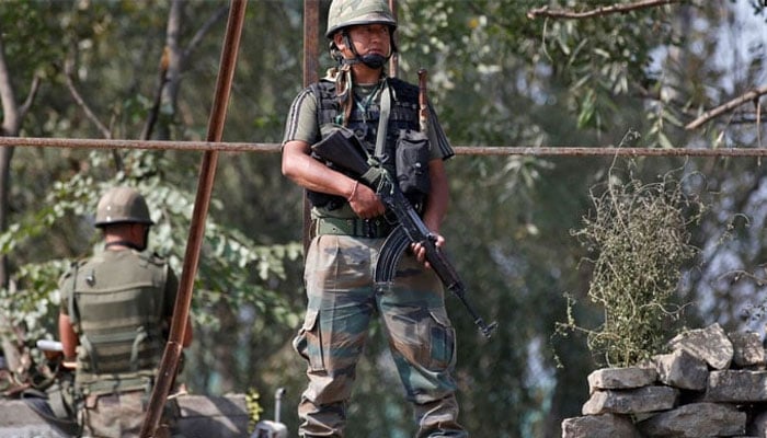 An undated image showing Indian army soldiers keep guard on top of a shop along a highway. — Reuters/File