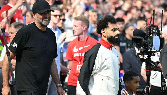 Jurgen Klopp walks out with Mohamed Salah before the Germans final match in charge of Liverpool last May. —AFP/File