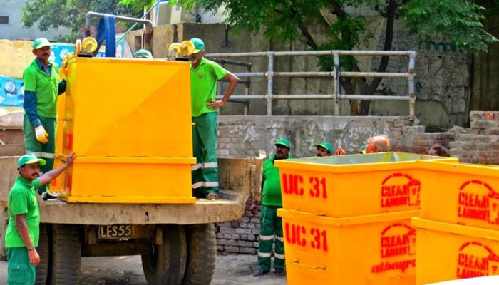 Staff of the Lahore Waste Management Company (LWMC) seen at work. — The News/Flie