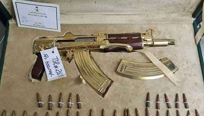 A golden AK-47, priced at Rs600,000, is also one of the items put on sale by the authorities. The image also shows 30 bullets along with the gun. — Geo.tv/File