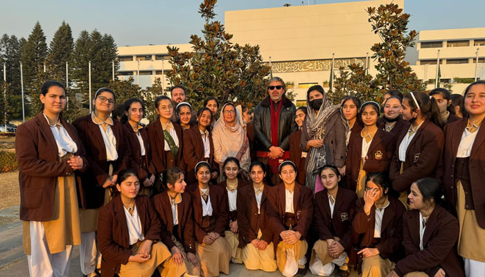 Girl students of Peshawar Millennium School Charsadda taking a group photo with PTI MNA Ali Muhammad Khan during their visit to the National Assembly in Islamabad on January 17. 2025.— Facebook@pmscharsadda