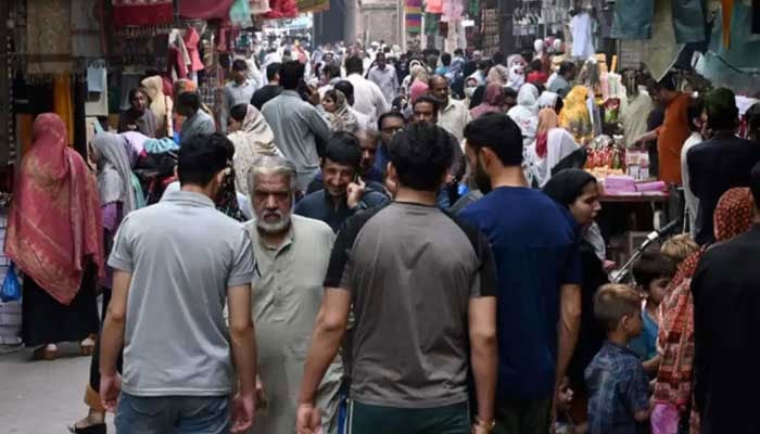 People throng a market area in Lahore. — AFP/File