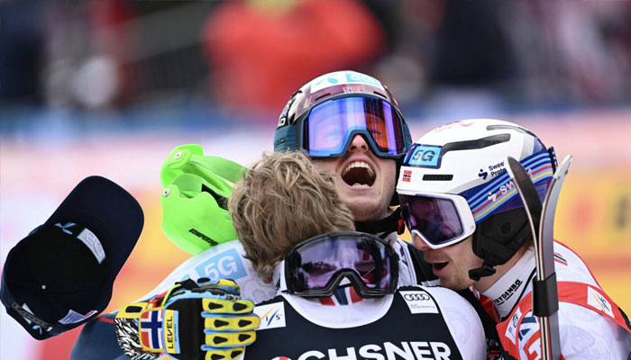 Atle Lie McGrath (centre) celebrates his win with compatriots Timon Haugan (left) and Henrik Kristoffersen (right) after their Norwegian podium sweep of the World Cup slalom in Wengen. —AFP/File