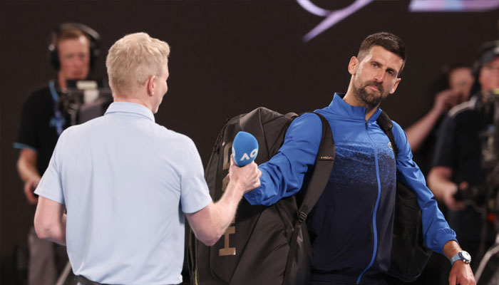 Serbias Novak Djokovic gives back the microphone after speaking briefly on court. —AFP/File