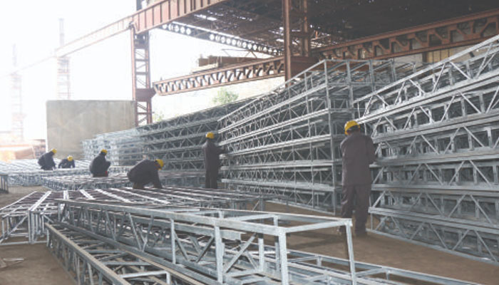 Workers working inside the Pakistan Engineering Company Limited. — Peco Website/File