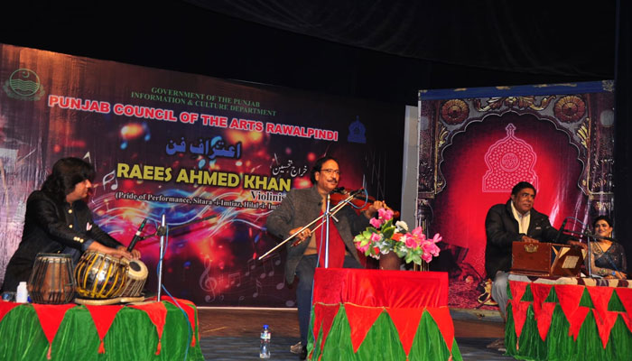 Internationally renowned violinist Ustad Raees Ahmed Khan (centre) performs during an event titled ‘Itiraf-e-fun’ organised by Punjab Arts Council (PAC) on January 23, 2025. — Facebook@artscouncilrawalpindi