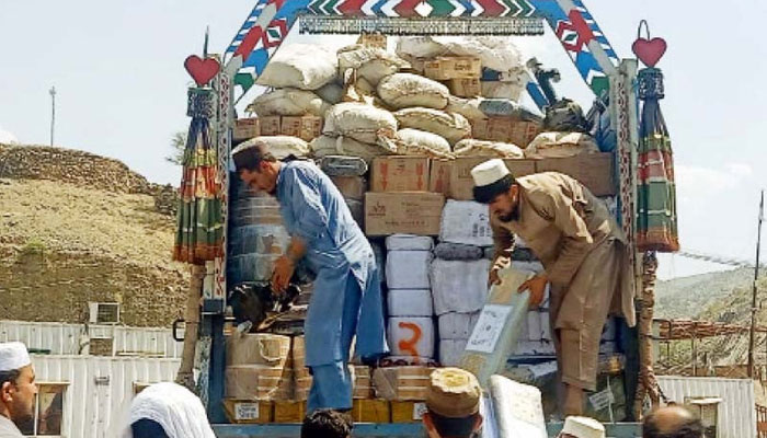 Custom officials inspect smuggled goods seized during an operation at the Torkham border at Landi Kotal. — PPI/File