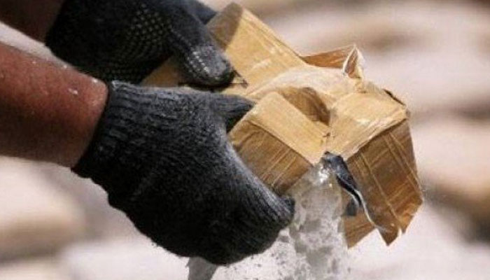A Customs officials seen handling a package in this undated image. — Reuters/File