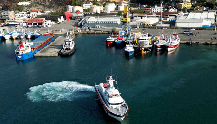 A drone view shows an Italian coast guard vessel departing for Italy with migrants, who were intercepted at sea and later detained at a reception facility in Albania, after a court in Rome overturned their detention orders, in Shengjin, Albania, October 19, 2024. — Reuters