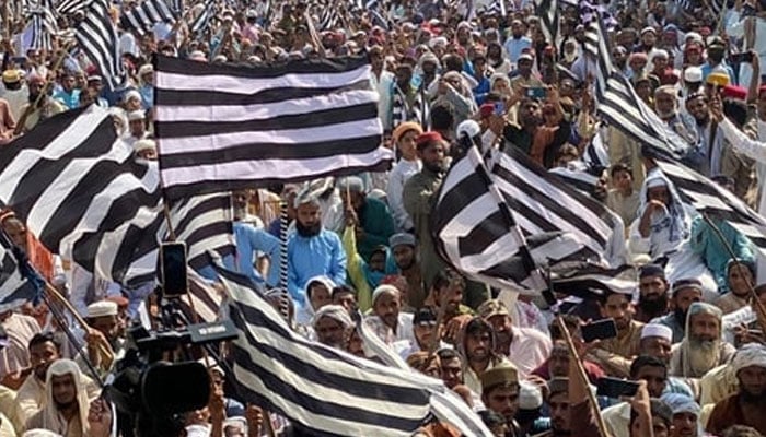 JUIF party supporters hold flags during a party rally in this image released on October 26, 2203. — Facebook@Jamiat Ulama-e-Islam Pakistan