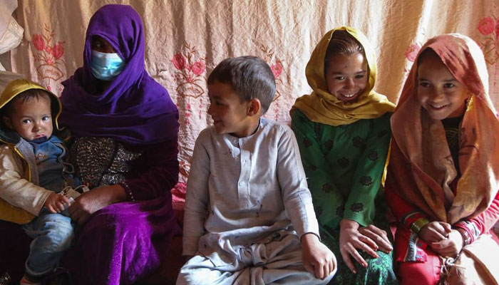 A family sit inside their home, in an informal settlement for internally displaced people in Kabul, Afghanistan. — AFP/File