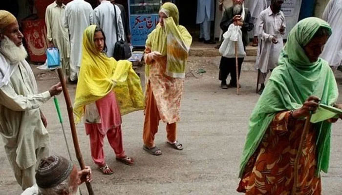 Beggars ask for alms outside a mosque in Karachi. — Reuters/File