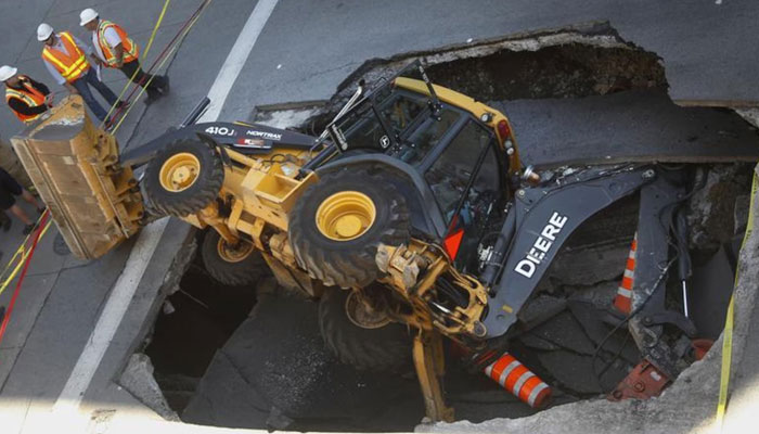 The representational image shows a construction vehicle as it was swallowed by a sinkhole on Saint-Catherine Street in downtown Montreal, August 5, 2013. — Reuters