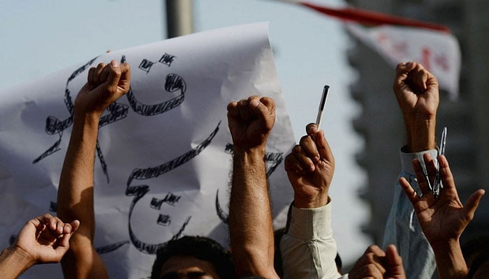 People raising their fists amid a protest in this undated image. — AFP/File
