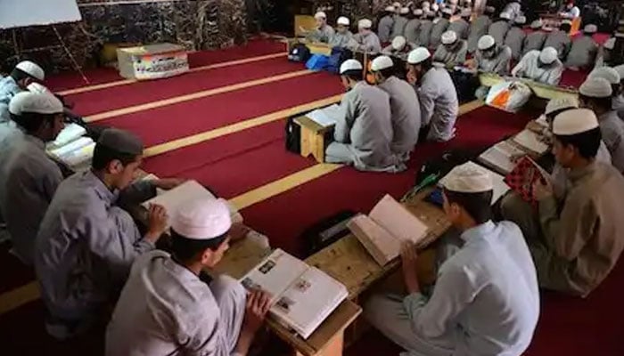Students attend class at a madrassa in Islamabad. — AFP/File
