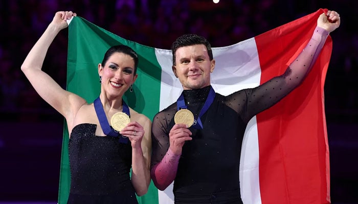 Italian figure skaters Charlene Guignard (left) and Marco Fabbri pose for the camera displaying their medals. — Reuters/File