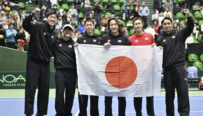 Japan celebrate their qualifying win over Britain in Miki.— AFP/File