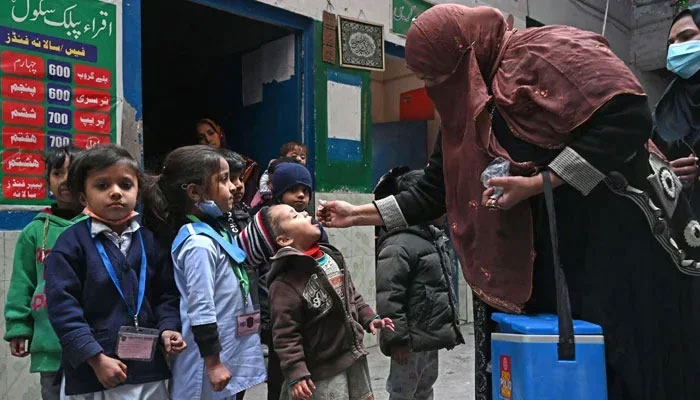 A health worker administers polio vaccine to children in this undated image. — AFP/File