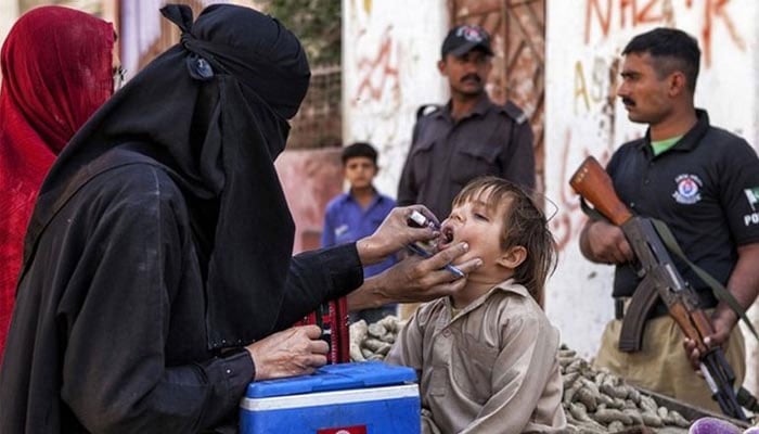 A polio worker administering polio vaccine to a child.— APP/File