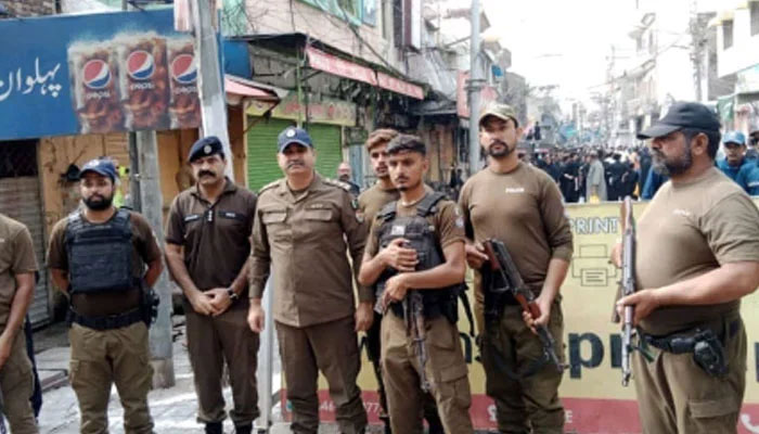 Punjab police personnel standing guard on the road on August 26, 2024. — Facebook@PunjabPolicePakistanOfficial