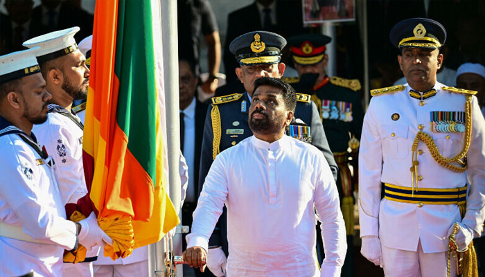 Sri Lanka’s President Anura Kumara Dissanayake (centre) prepares to hoist the national flag during the country’s 77th Independence Day celebrations at the Independence Square in Colombo on February 4. — AFP
