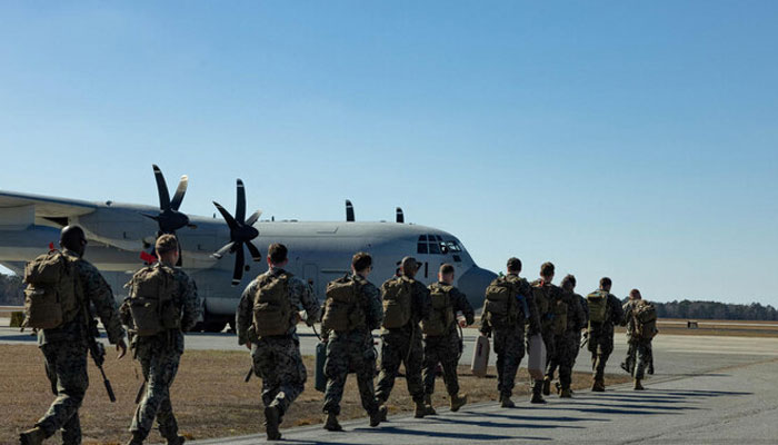 US Marines, heading to the US naval base at Guantanamo Bay, walk toward a C-130 Hercules plane at Marine Corps Air Station New River in Jacksonville, North Carolina, US, February 1, 2025. — Reuters